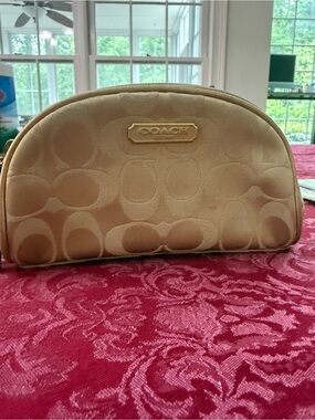 Coach Satin Signature Cosmetic Pouch Champagne  has like 3 small
marks I point